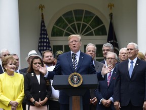 President Donald Trump participates in a bill signing ceremony for the "VA Mission Act" in the Rose Garden of the White House, Wednesday, June 6, 2018, in Washington.  The legislation authorizes new health care programs for veterans, but the bill does not reserve federal money to pay for those programs.