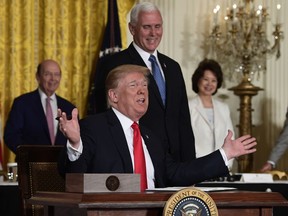 President Donald Trump gestures as he signs a "Space Policy Directive" during a meeting of the National Space Council in the East Room of the White House, Monday, June 18, 2018, in Washington, as Vice President Mike Pence watches.  AP Photo/Susan Walsh)