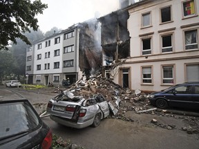 A car and a house are destroyed after an explosion in Wuppertal, Germany, June 24, 2018. German police say 25 people were injured, when an explosion destroyed a several-store building in the western city of Wuppertal.