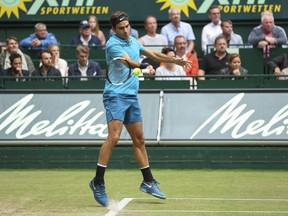 Roger Federer returns the ball to Boran Coric during the final match at the Gerry Weber Open ATP tennis tournament in Halle, Germany, Sunday, June 24, 2018.