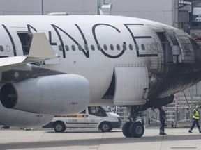 A plane of the Star Alliance is damaging after a push-car caught fire at the airport in Frankfurt, Monday, June 11, 2018.