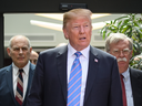 U.S. President Donald Trump leaves with Chief of Staff John Kelly, left, and National Security Advisor John Bolton after holding a press conference ahead of his early departure from the G7 Summit on June 9, 2018 in La Malbaie, Quebec.