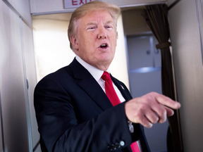 U.S. President Donald Trump speaks to reporters aboard Air Force One on June 29, 2018.
