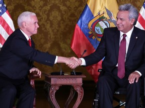 Ecuador's President Lenin Moreno, right, shakes hand with U.S. Vice President Mike Pence at the government palace in Quito, Ecuador, Thursday, June 28, 2018.
