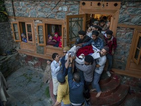 Relatives and neighbours carry body of Qaiser Amin Bhat, for his funeral in Srinagar, Indian controlled Kashmir, Saturday, June 2, 2018. Government forces in Indian-controlled Kashmir Saturday fired shotgun pellets and tear gas at hundreds of mourners in the disputed region's main city as they carried the body of a young man killed the other day after a paramilitary vehicle run over him, police and residents said.