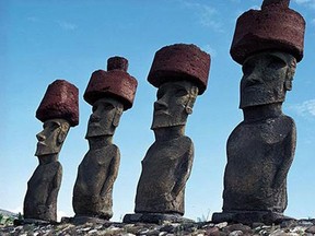 Four Easter Island statues with hats made of red scoria. The accessories have long caused speculation among scholars.