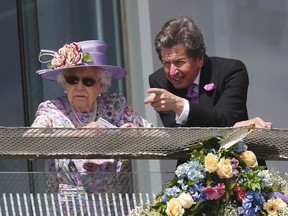 Queen Elizabeth II stands next racing manager John Warren during derby day of the 2018 Investec Derby Festival at Epsom Downs Racecourse, Britain, Saturday, June 2, 2018.