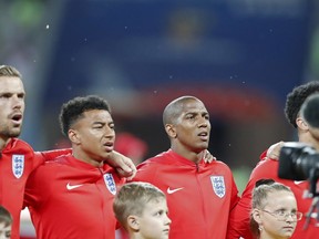 Flies surround the English team during the anthem prior the group G match between Tunisia and England at the 2018 soccer World Cup in the Volgograd Arena in Volgograd, Russia, Monday, June 18, 2018.