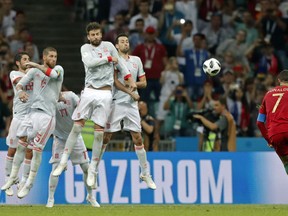 Portugal's Cristiano Ronaldo scores his third goal with a free kick during the group B match between Portugal and Spain at the 2018 soccer World Cup in the Fisht Stadium in Sochi, Russia, Friday, June 15, 2018.
