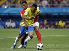 Switzerland's Manuel Akanji rear, and Brazil's Gabriel Jesus challenge for the ball during the group E match between Brazil and Switzerland at the 2018 soccer World Cup in the Rostov Arena in Rostov-on-Don, Russia, Sunday, June 17, 2018.