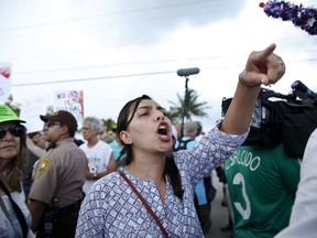 A protester yells toward a Trump supporter after arriving to the Homestead Temporary Shelter for Unaccompanied Children, on Saturday, June 23, 2018, in Homestead, Fla.