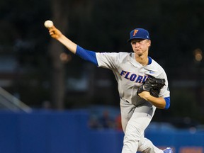 This photo taken June 2, 2018, shows Florida's Brady Singer pitching against Jacksonville during an NCAA college baseball tournament regional game  in Gainesville, Fla. The Gators ace has been in the discussion since last year to be the No. 1 overall pick in this year's draft with his mid-90s fastball and solid slider. A slow start to Singer's season and a recent hamstring issue, combined with a terrific year by Auburn's Casey Mize likely have the Florida righty instead going within the top five selections.