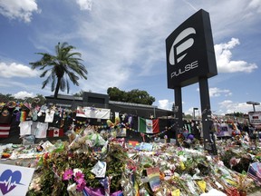 FILE - In this July 11, 2016, file photo, a makeshift memorial continues to grow outside the Pulse nightclub, the day before the one month anniversary of a mass shooting, in Orlando, Fla. Survivors and victims' relatives are marking the second anniversary of the Pulse nightclub shooting with a remembrance ceremony, a run, art exhibits and litigation.