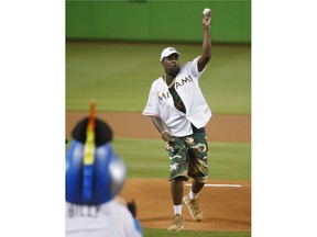 Cuban musical artist El Micha throws out a ceremonial first pitch before a baseball game between the Miami Marlins and the Arizona Diamondbacks, Tuesday, June 26, 2018, in Miami.