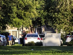 Police said a man suspected of battering his girlfriend wounded a police officer late Sunday and barricaded himself inside an apartment with several young children.