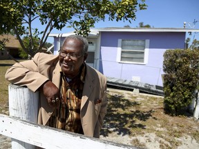 This photo taken March 18, 2018, shows David Baldwin standing  in front of his mother's home in Dansville, Fla. "It was her color," says Baldwin, of his mother's bright lavender house, as he pictures her on the white front porch. Ollie Mae Henry was Dan's daughter. Years after her death in 2014, her house sits empty but for her son's visits.