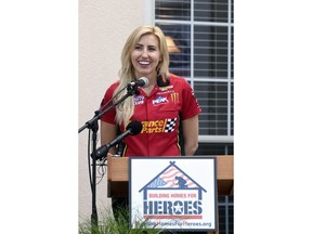 NHRA drag racer Courtney Force speaks during a ceremony Wednesday June 13, 2018 in Navarre, Florida in which widow Natasha De Alencar and her children received a new home through the Building Homes for Heroes non-profit organization. De Alencar's husband, U.S. Army Special Forces Staff Sgt. Mark De Alencar, died April 8, 2017 while serving in Afghanistan. Force was there representing Advance Auto Parts, one of the sponsors of Building Homes for Heroes.