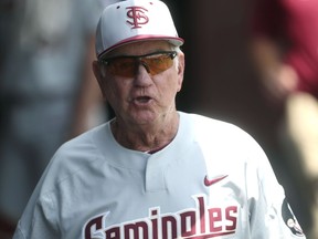 FILE - In this June 2, 2018, file photo, Florida State head coach Mike Martin yells out to his team from the dugout during an NCAA college baseball tournament regional game against Mississippi State, in Tallahassee, Fla. Florida State has announced that Mike Martin will retire as baseball coach at the end of the 2019 season. Martin, who has led the Seminoles since 1980, became college baseball's wins leader in May.