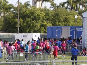 Immigrant children play outside a former Job Corps site that now houses them, Monday, June 18, 2018, in Homestead, Fla. It is not known if the children crossed the border as unaccompanied minors or were separated from family members. An unapologetic President Donald Trump defended his administration's border-protection policies Monday in the face of rising national outrage over the forced separation of migrant children from their parents.