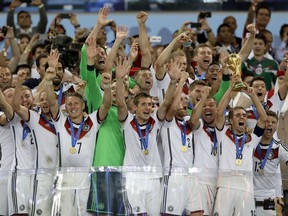 FILE - In this July 13, 2014 file photo Germany's Philipp Lahm holds up the World Cup trophy as the team celebrates their 1-0 victor over Argentina after the World Cup final soccer match between Germany and Argentina at the Maracana Stadium in Rio de Janeiro, Brazil. The soccer world gathers at 12 stadiums in 11 cities across the European portion of Russia starting June 14 for a 32-day, 64-match World Cup.
