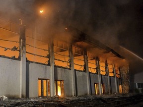 FILE - The Aug. 25, 2018 file photo shows a burning gym in Nauen, eastern Germany. A German federal court has overturned a far-right politician's conviction for burning down a the building intended as refugee housing and ordered a retrial.