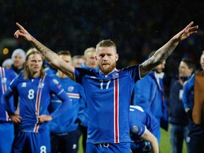 FILE - In this Monday Oct. 9, 2017 filer, Iceland's captain Aron Gunnarsson celebrates at the end of the World Cup Group I qualifying soccer match between Iceland and Kosovo in Reykjavik, Iceland. Icelandic footballers are the tallest at the World Cup in Russia, with an average height of 1.85 meters (just over 6 feet), making them especially strong in aerial duels in defense and attack.