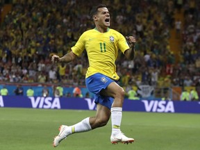 Brazil's Philippe Coutinho celebrates with teammates after scoring his side's opening goal during the group E match between Brazil and Switzerland at the 2018 soccer World Cup in the Rostov Arena in Rostov-on-Don, Russia, Sunday, June 17, 2018.