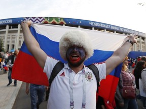 A Russian fans celebrates after his team won the opening match between Russia and Saudi Arabia during the 2018 soccer World Cup at the Luzhniki stadium in Moscow, Russia, Thursday, June 14, 2018.