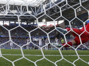 Iceland goalkeeper Hannes Halldorsson, right, saves a penalty by Argentina's Lionel Messi during the group D match between Argentina and Iceland at the 2018 soccer World Cup in the Spartak Stadium in Moscow, Russia, Saturday, June 16, 2018.