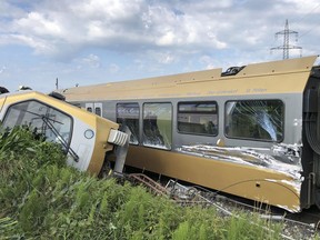 A carriage lies on its side after a train derailed near St. Poelten, Austria, Tuesday, June 26, 2018. Two people were seriously injured when the passenger train derailed on the local railway. (einsatzdoku.at via AP)