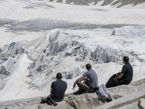 People visit the Rhone Glacier covered in blankets above Gletsch near the Furkapass in Switzerland, Tuesday, 19 June 2018. The Alps oldest glacier is protected by special white blankets to prevent it from melting.