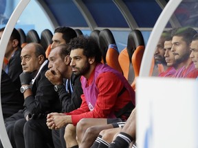 Egypt's Mohamed Salah, center, watches his team during the group A match between Egypt and Uruguay at the 2018 soccer World Cup in the Yekaterinburg Arena in Yekaterinburg, Russia, Friday, June 15, 2018.