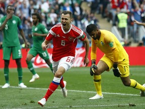 Russia's Denis Cheryshev celebrates after scoring his side's second goal during the group A match between Russia and Saudi Arabia which opens the 2018 soccer World Cup at the Luzhniki stadium in Moscow, Russia, Thursday, June 14, 2018.