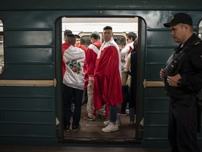 In this June 14, 2018 photo soccer fans ride in the metro near the Luzhniki stadium before the group A match between Russia and Saudi Arabia which opens the 2018 soccer World Cup in Moscow, Russia.