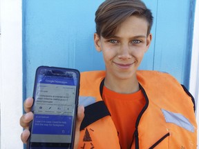 Marat Gurjan, a 15-year-old lifeguard, poses for a picture showing his phone with a note in Russian and English on Google Translate in Samara, Russia, Tuesday June 19, 2018. Google Translate has been key to leap over the language barrier at the World Cup in Russia. Fans have also used the mobile app to order food, change money and meet new people, especially in cities like Samara, where few people speak anything but Russian.