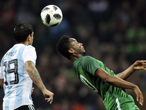 FILE - In this Nov. 14, 2017 filer, Argentina's Ever Banega, left, challenges for the ball with Nigeria's John Obi Mikel during the international friendly soccer match between Argentina and Nigeria in Krasnodar, Russia.