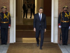 Spain's new Prime Minister Pedro Sanchez steps out to meet Ukrainian President Petro Poroshenko before their meeting at the Moncloa palace in Madrid, Monday, June 4, 2018. Opposition Socialist leader Pedro Sanchez won the vote last week to replace Mariano Rajoy as Prime Minister, in the first ouster of a serving Spanish leader by parliament in four decades of democracy.