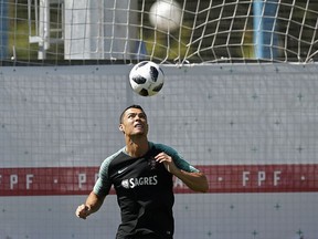 Portugal's Cristiano Ronaldo heads the ball during the training session of Portugal at the 2018 soccer World Cup in Kratovo, outskirts Moscow, Russia, Friday, June 22, 2018.