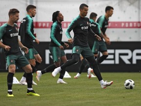 Portugal's Cristiano Ronaldo, right, plays the ball with teammates during the training session of Portugal at the 2018 soccer World Cup in Kratovo, outskirts Moscow, Russia, Wednesday, June 13, 2018.