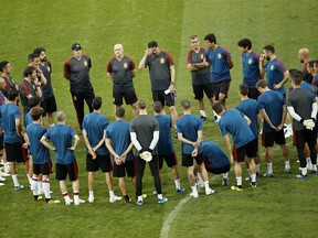 Spain head coach Fernando Hierro, top centre, touches his forehead as gives instructions to his players during Spain's official training on the eve of the group B match between Portugal and Spain at the 2018 soccer World Cup in the Fisht Stadium in Sochi, Russia, Thursday, June 14, 2018.