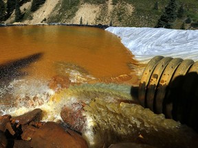 FILE - In this Aug. 14, 2015, file photo, water flows through a series of sediment retention ponds built to reduce heavy metal and chemical contaminants from the Gold King Mine outside Silverton, Colo. The Gold King and other mines in the area are now part of a Superfund cleanup project. The U.S. Environmental Protection Agency announced Thursday, June 14, 2018, it plans to take a series of interim cleanup steps at some of the sites while it searches for a longer-term solution.