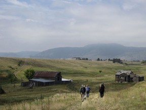 In this Aug. 11, 2017 photo, visitors approach a former ranch house and barn during a guided hike on the Rocky Flats National Wildlife Refuge near Denver. Rocky Flats was once the site of a plant that made plutonium triggers for nuclear weapons. Part of the site was designated a refuge after a $7 billion cleanup. On Sunday, June 3, 2018, the refuge manager harshly criticized a local Colorado health officer who questioned the safety of the site and expressed doubt about whether the U.S. government's assurances about the site could be trusted.