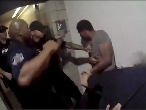 This image made from a body camera video on Wednesday, May 23, 2018, released by the Mesa Police Department shows police officers approaching a man in Mesa, Ariz. A report from the incident states the man, Robert Johnson, was "verbally defiant and confrontational." Mesa police released the report, along with footage from police-worn cameras, on Wednesday, June 6, after video released by Johnson's attorneys circulated this week, raising criticism over the handling of the incident. (Mesa Police Department via AP)