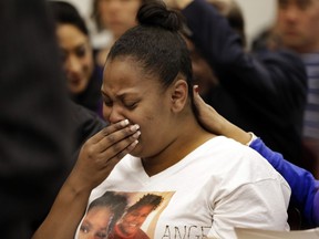 FILE - In this Dec. 20, 2013 file photo, Nailah Winkfield, mother of 13-year-old Jahi McMath, cries before a courtroom hearing regarding McMath, in Oakland, Calif. New Jersey officials say McMath, the girl at the center of the medical and religious debate over brain death, has died from excessive bleeding. The girl's mother said Thursday, June 28, 2018, that New Jersey doctors declared Jahi McMath dead after an operation to treat an intestinal issue. A California coroner in 2013 ruled the then 13-year-old died after suffering irreversible brain damage during an operation to remove her tonsils. Her family did not accept the decision and opted to move her to New Jersey.