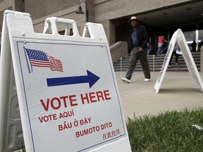 FILE - In this Oct. 24, 2016 file photo, signs direct voters outside of the Santa Clara County Registrar of Voters in San Jose, Calif. California's primary election on Tuesday, June 5, 2018, includes races for governor, U.S. Senate and other statewide offices, all 53 U.S. districts and most seats in the Legislature.