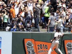 CORRECTS TO THIRD INNING- San Francisco Giants left fielder Mac Williamson (51) leaps in vain for a solo home run by Philadelphia Phillies Jake Arrieta during the third inning of a baseball game, Sunday, June 3, 2018, in San Francisco.