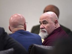 Frank Gebhardt, right, confers with his attorney Larkin Lee during his murder trial at the Spalding County Courthouse on Tuesday, June 26, 2018 in Griffin, Ga.  Gebhardt is accused of the 1983 killing of Timothy Coggins, who witnesses said was stabbed 30 times and dragged behind a pickup truck.