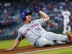 New York Mets' Jay Bruce (19) slides into third base on a fly ball by Kevin Plawecki during the fourth inning of a baseball game against the Atlanta Braves on Wednesday, May 30, 2018, in Atlanta. New York won 4-1.