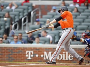 Baltimore Orioles designated hitter Mark Trumbo hits a grand slam in the first inning of a baseball game against the Atlanta Braves, Saturday, June 23, 2018, in Atlanta.