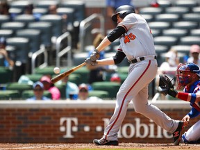 Baltimore Orioles pinch hitter Mark Trumbo (45) hits a two run home run in the fifth inning of a baseball game against the Atlanta Braves, Sunday, June 24, 2018, in Atlanta.